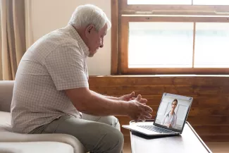 Older man looking at a computer